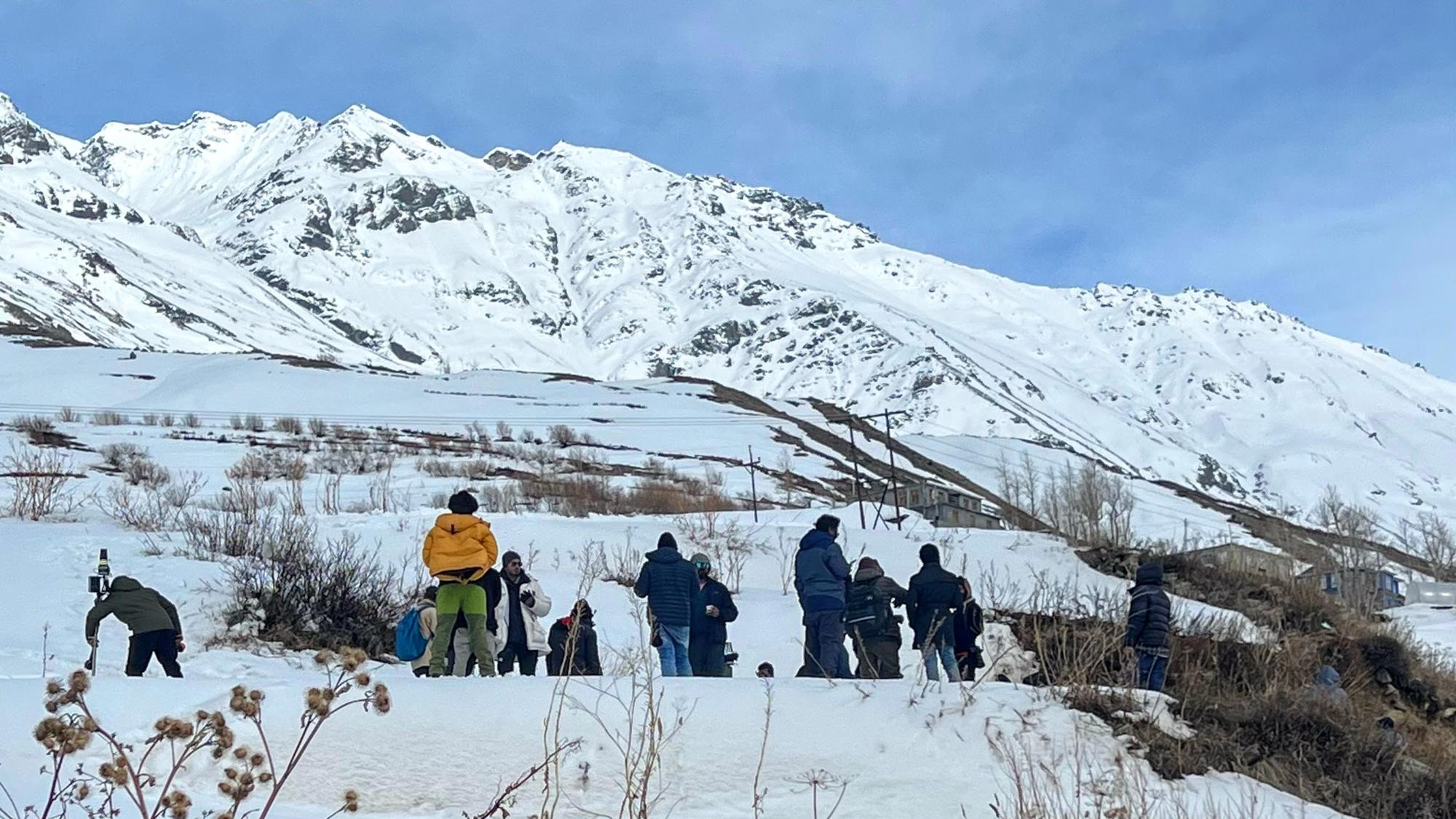 A production crew on a snow-covered location in Sissu